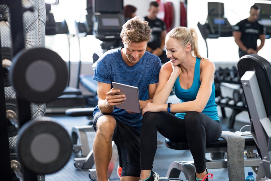 fitness trainer coaching a client in the gym