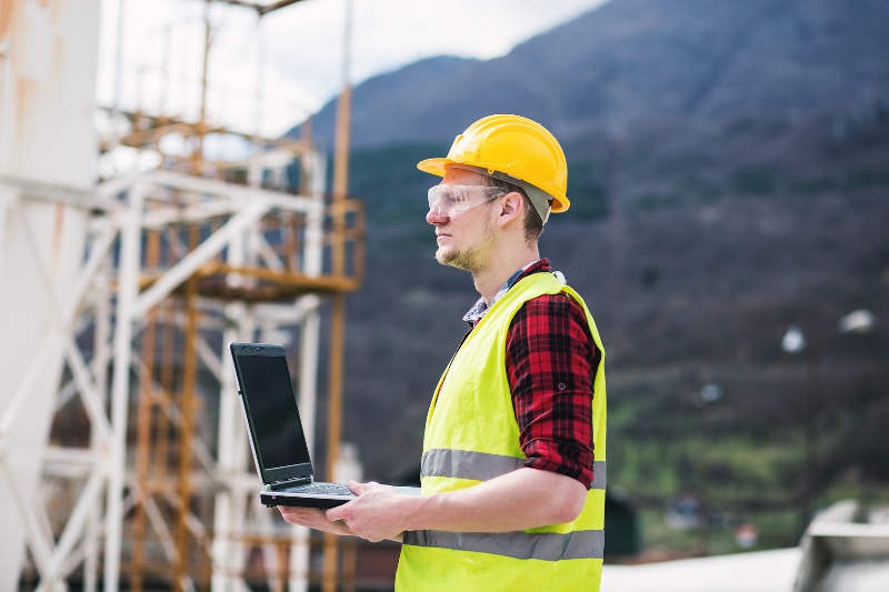 construction worker holding laptop