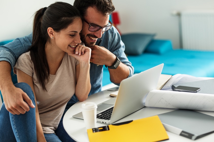 man and woman looking at laptop