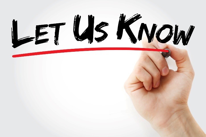 hand writing 'let us know' on wall