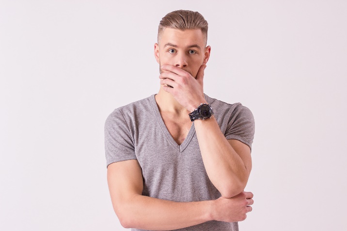 shocked man covering his mouth