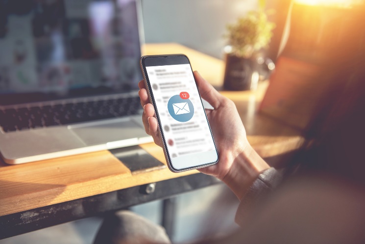 man looking at his email on his smartphone